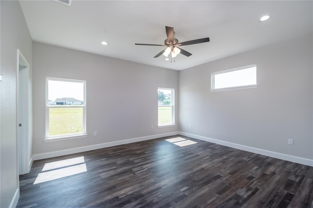 spare room with ceiling fan and dark hardwood / wood-style floors