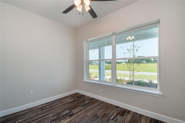 empty room featuring dark wood-type flooring and ceiling fan