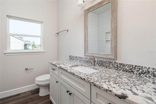 bathroom featuring toilet, hardwood / wood-style flooring, and vanity