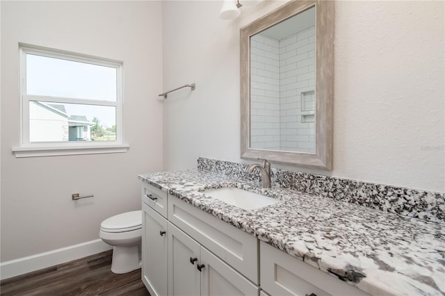 2073 NW 79th Loop, Ocala, FL 34475 - bathroom with wood finished floors, vanity, toilet, and baseboards