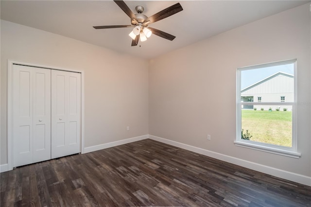 unfurnished bedroom featuring dark hardwood / wood-style floors, a closet, and ceiling fan