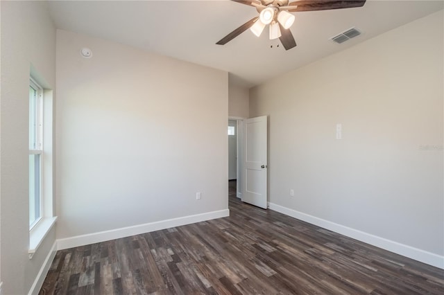 empty room featuring ceiling fan and dark hardwood / wood-style flooring