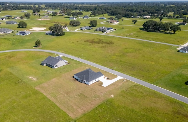 birds eye view of property with a rural view