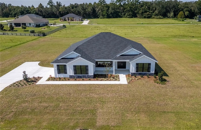 exterior space featuring a rural view and a front lawn