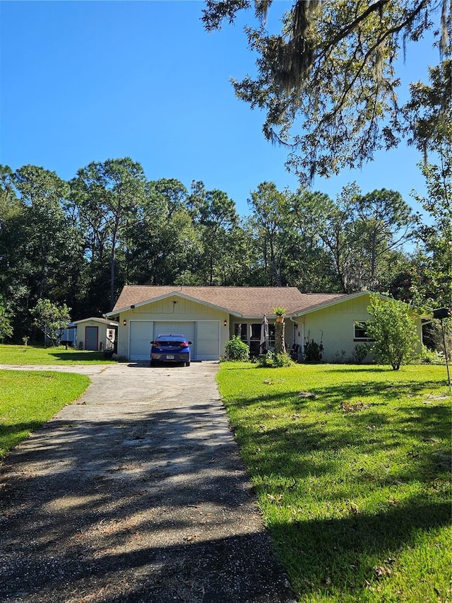 single story home with a garage and a front lawn