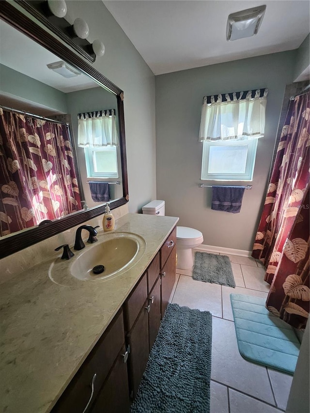 bathroom featuring toilet, tile patterned flooring, and vanity