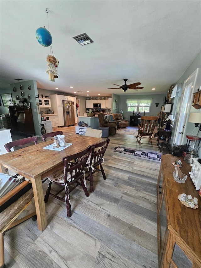 dining area featuring ceiling fan and hardwood / wood-style flooring