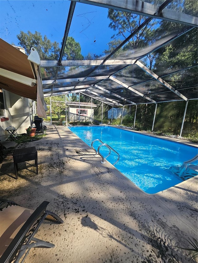 view of pool featuring a patio and a lanai