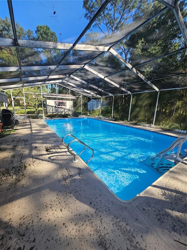 view of swimming pool with a patio and glass enclosure