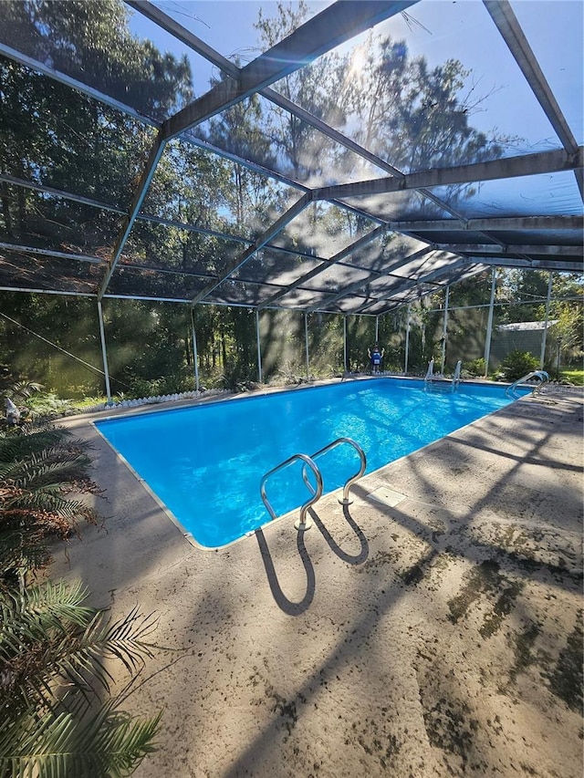 view of pool featuring a lanai and a patio area