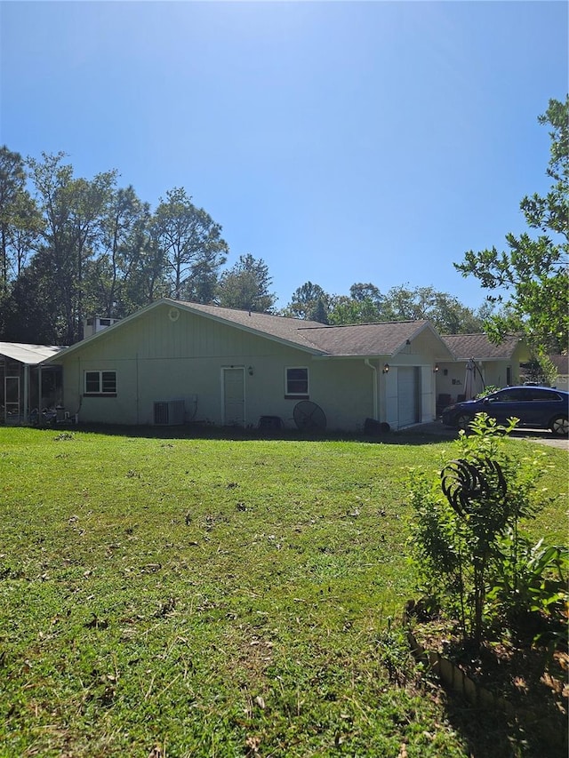 view of side of property with a lawn