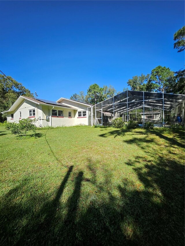 view of yard featuring a lanai