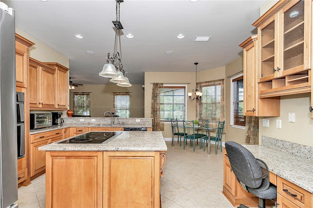 kitchen featuring black electric stovetop, a center island, and pendant lighting