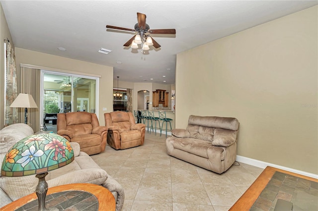 tiled living room with ceiling fan