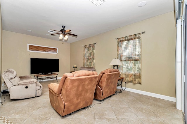 living room featuring light tile patterned floors and ceiling fan