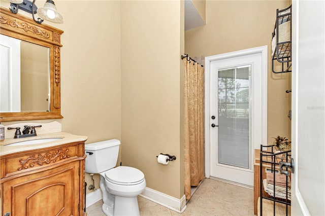 bathroom featuring vanity, a shower with curtain, toilet, and tile patterned flooring