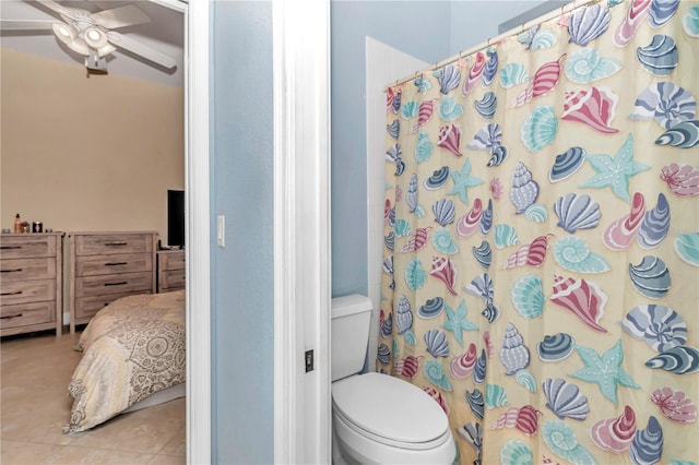 bathroom with tile patterned floors, curtained shower, toilet, and ceiling fan