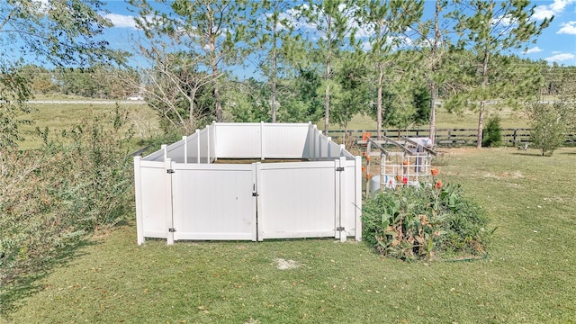 view of outbuilding featuring a lawn