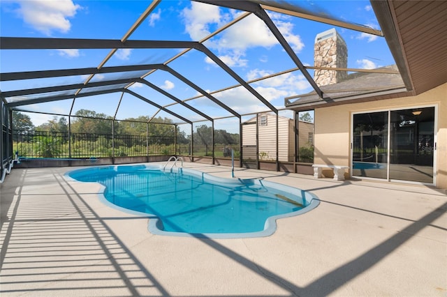 view of swimming pool with a patio and glass enclosure