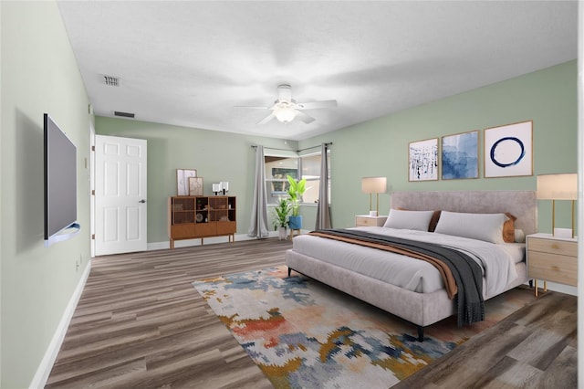 bedroom with ceiling fan and dark wood-type flooring