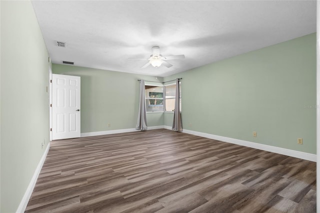 unfurnished bedroom with ceiling fan, dark hardwood / wood-style flooring, and a textured ceiling