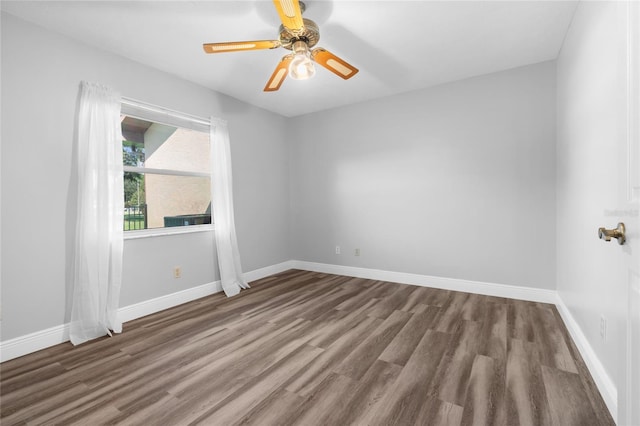 unfurnished room with ceiling fan and dark hardwood / wood-style floors