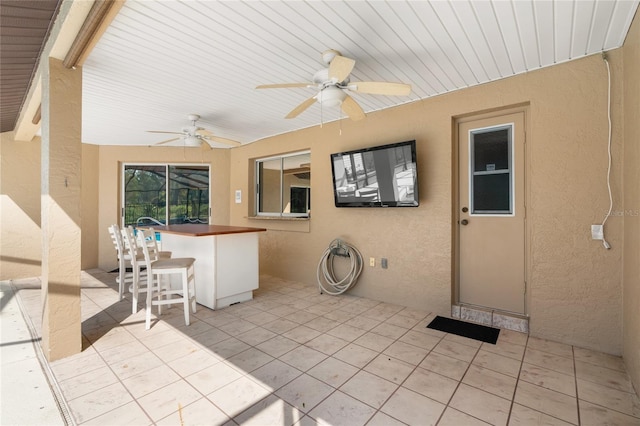 view of patio / terrace featuring ceiling fan and an outdoor bar