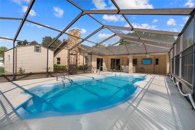 view of pool featuring a patio area, ceiling fan, and glass enclosure