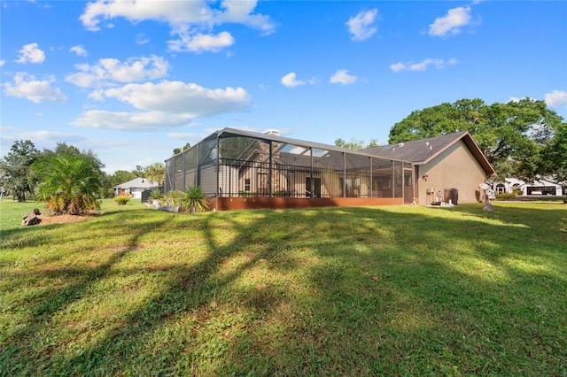 back of property featuring a lawn and a lanai