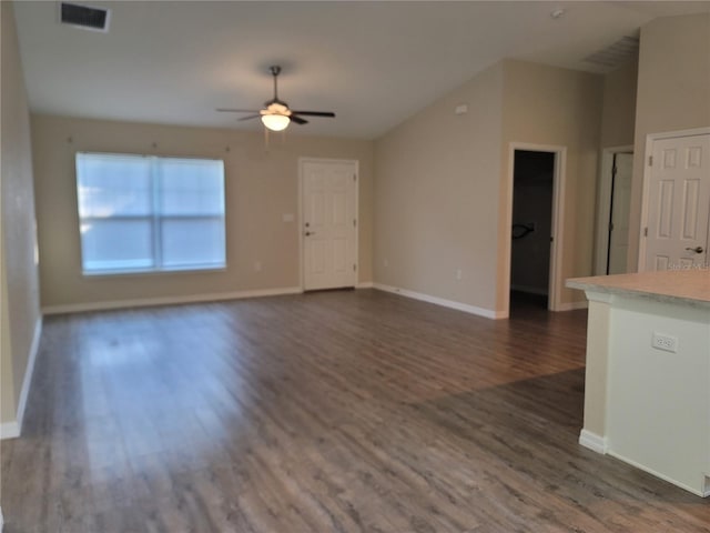 unfurnished living room with dark hardwood / wood-style flooring and ceiling fan