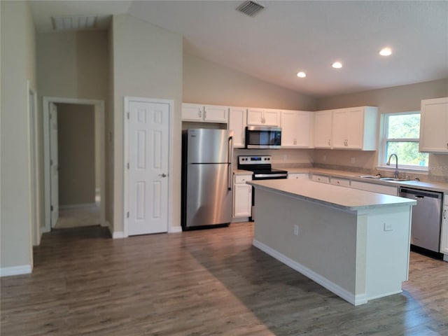 kitchen featuring sink, stainless steel appliances, dark hardwood / wood-style floors, white cabinets, and a center island