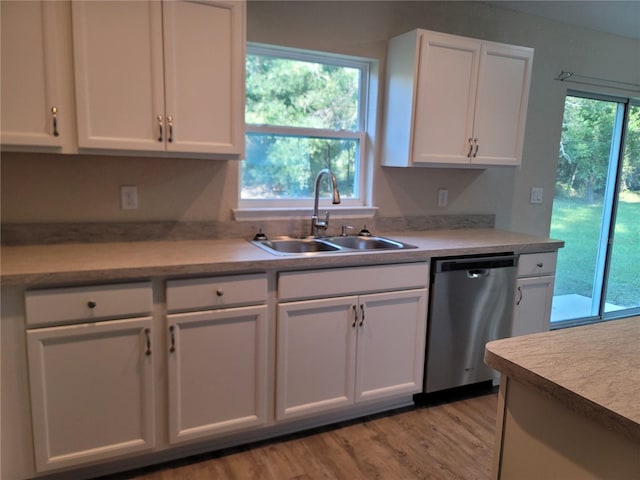 kitchen featuring white cabinets, light wood-type flooring, sink, and stainless steel dishwasher