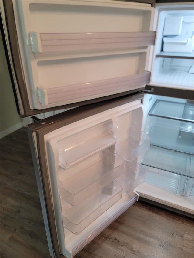 details with dark wood-type flooring and white refrigerator