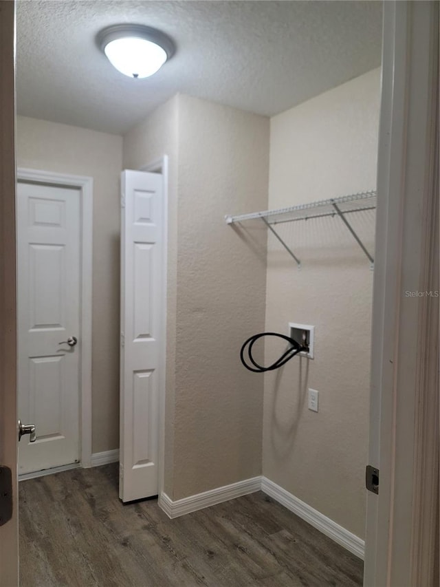 clothes washing area featuring dark wood-type flooring and hookup for a washing machine