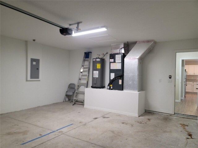 garage featuring a garage door opener, heating unit, electric water heater, and electric panel