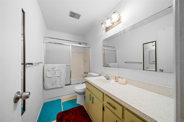 full bathroom featuring tile patterned floors, vanity, toilet, and bath / shower combo with glass door