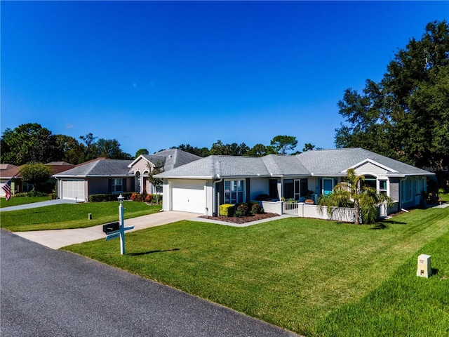 ranch-style house with a front lawn, a porch, and a garage