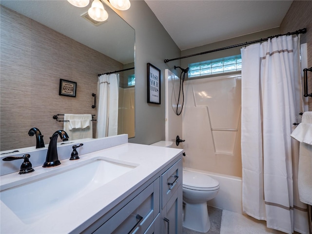 full bathroom featuring vanity, shower / tub combo, and toilet