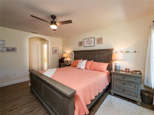 bedroom featuring ceiling fan, dark wood-type flooring, and a textured ceiling