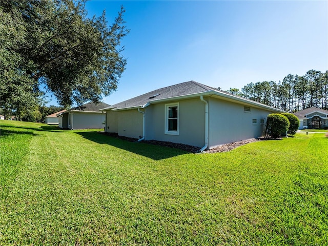 view of side of home with a lawn