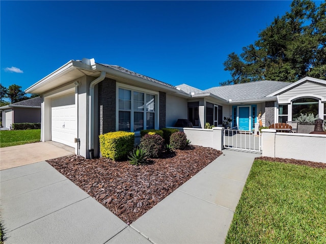 single story home with a garage and a front lawn