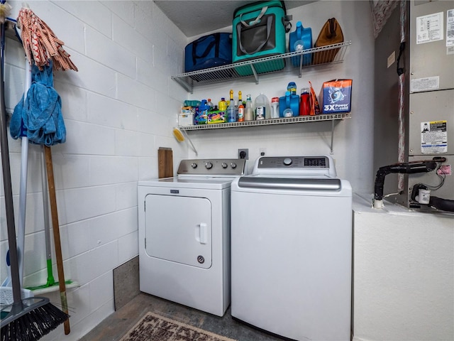 washroom featuring independent washer and dryer and heating unit