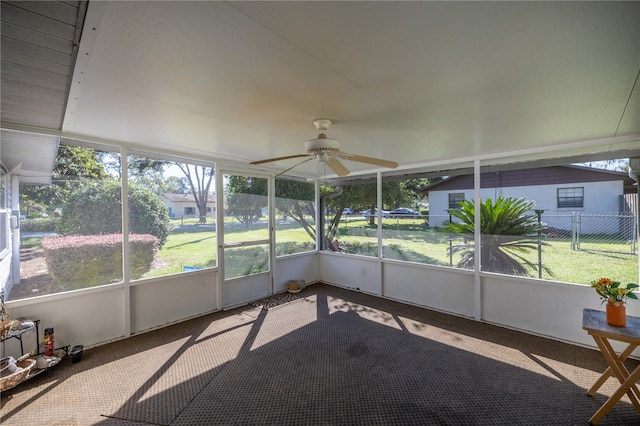 sunroom / solarium with plenty of natural light and ceiling fan