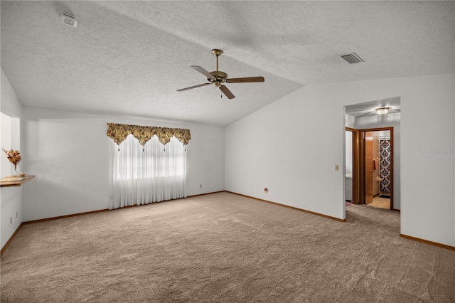 spare room with lofted ceiling, light carpet, a textured ceiling, and ceiling fan