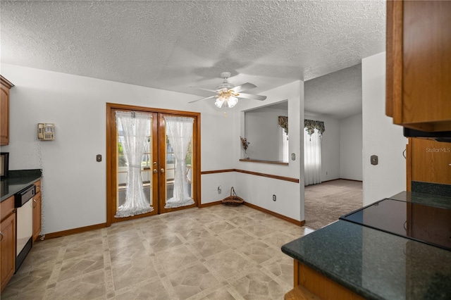 kitchen featuring dishwasher, french doors, a textured ceiling, and ceiling fan