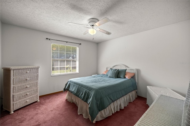 carpeted bedroom featuring ceiling fan and a textured ceiling