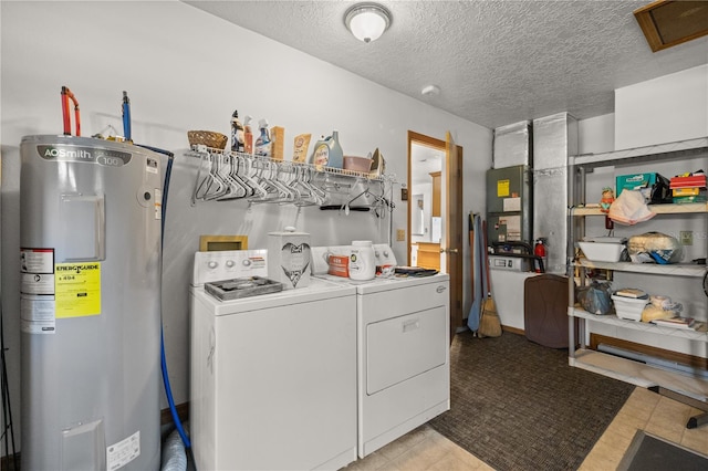 washroom featuring separate washer and dryer, water heater, heating unit, and a textured ceiling