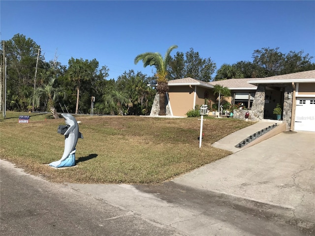 view of front of property with a garage and a front lawn