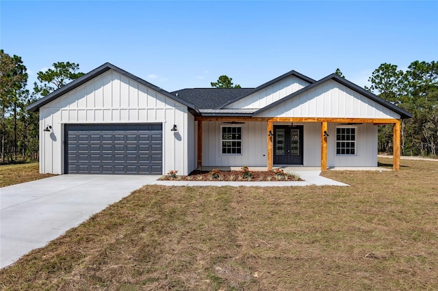 modern farmhouse with a porch, a garage, and a front lawn