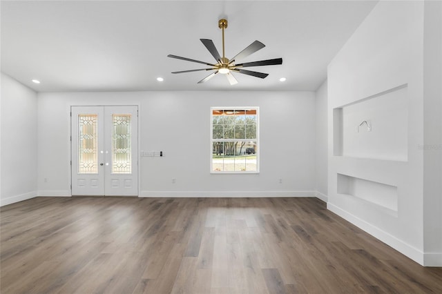 unfurnished living room featuring ceiling fan, dark hardwood / wood-style flooring, and french doors